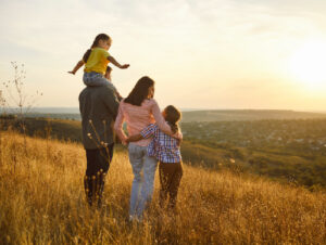 Family in a meadow at sunset